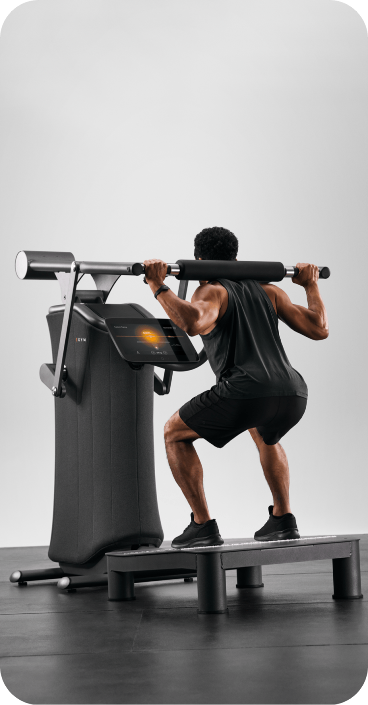 Man squats on EGYM machine.