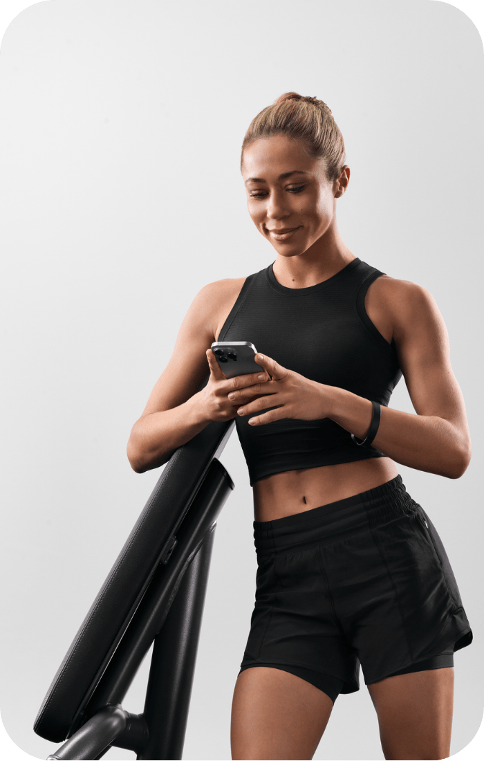 Woman checking her training via EGYM App.